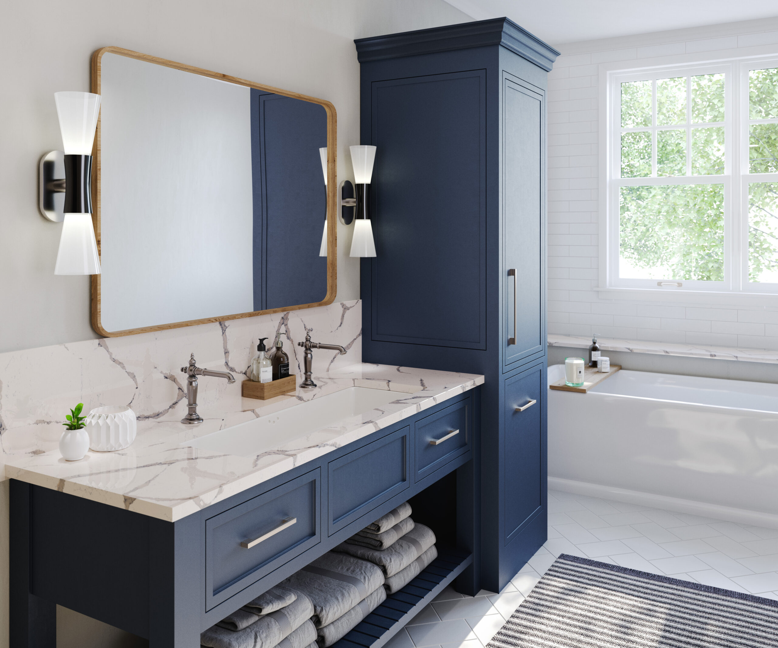 Modern bathroom featuring a navy vanity with a marble countertop, stylish wall sconces, and a large mirror. Natural light illuminates the space.