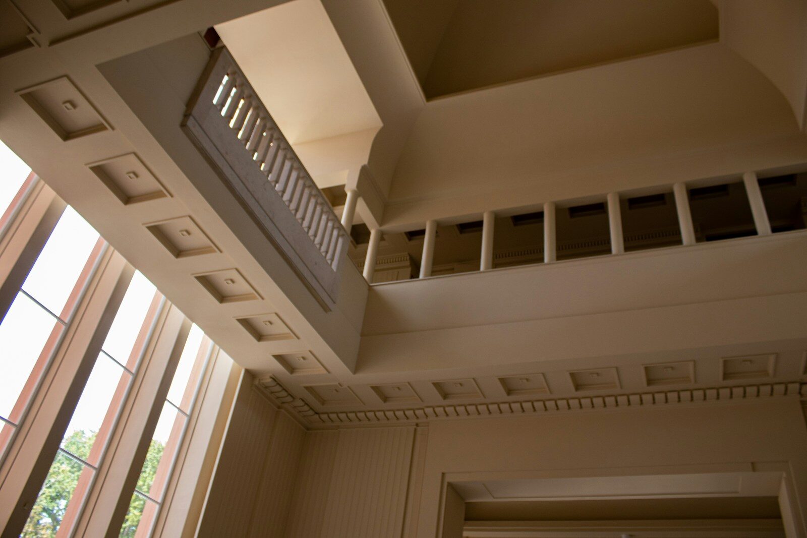 a room with a balcony and several windows